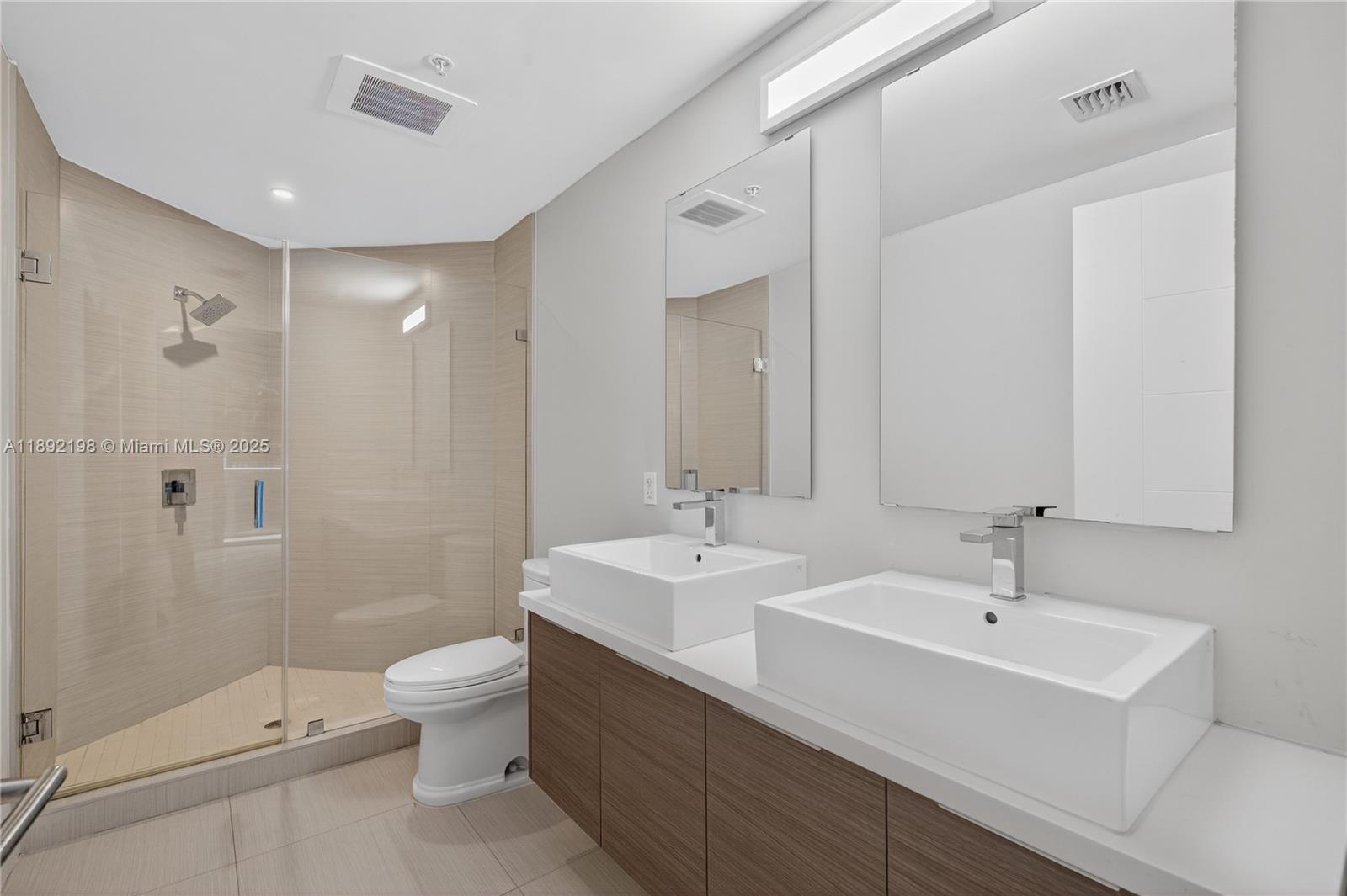 1010 Southwest 2nd Avenue, Unit 603 Miami, FL 33130 - Photo 40 of 84 a bathroom with a double vanity sink toilet and shower