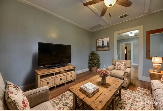 a living room with furniture and a flat screen tv
