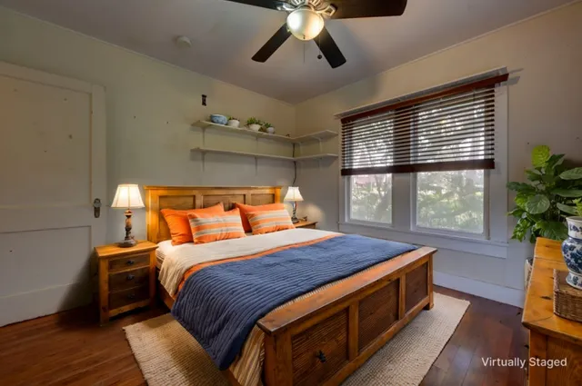 a bed sitting in a bedroom next to a window