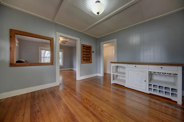 wooden floor in an empty room with a window