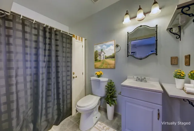 a bathroom with a sink vanity mirror and toilet
