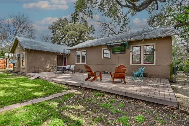 a view of a house with backyard porch and sitting area