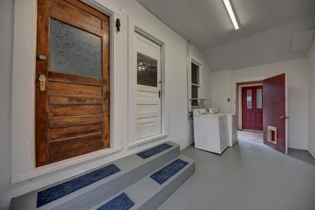 a view of empty room with window and cabinet