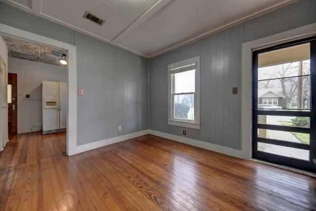 wooden floor in an empty room with a window