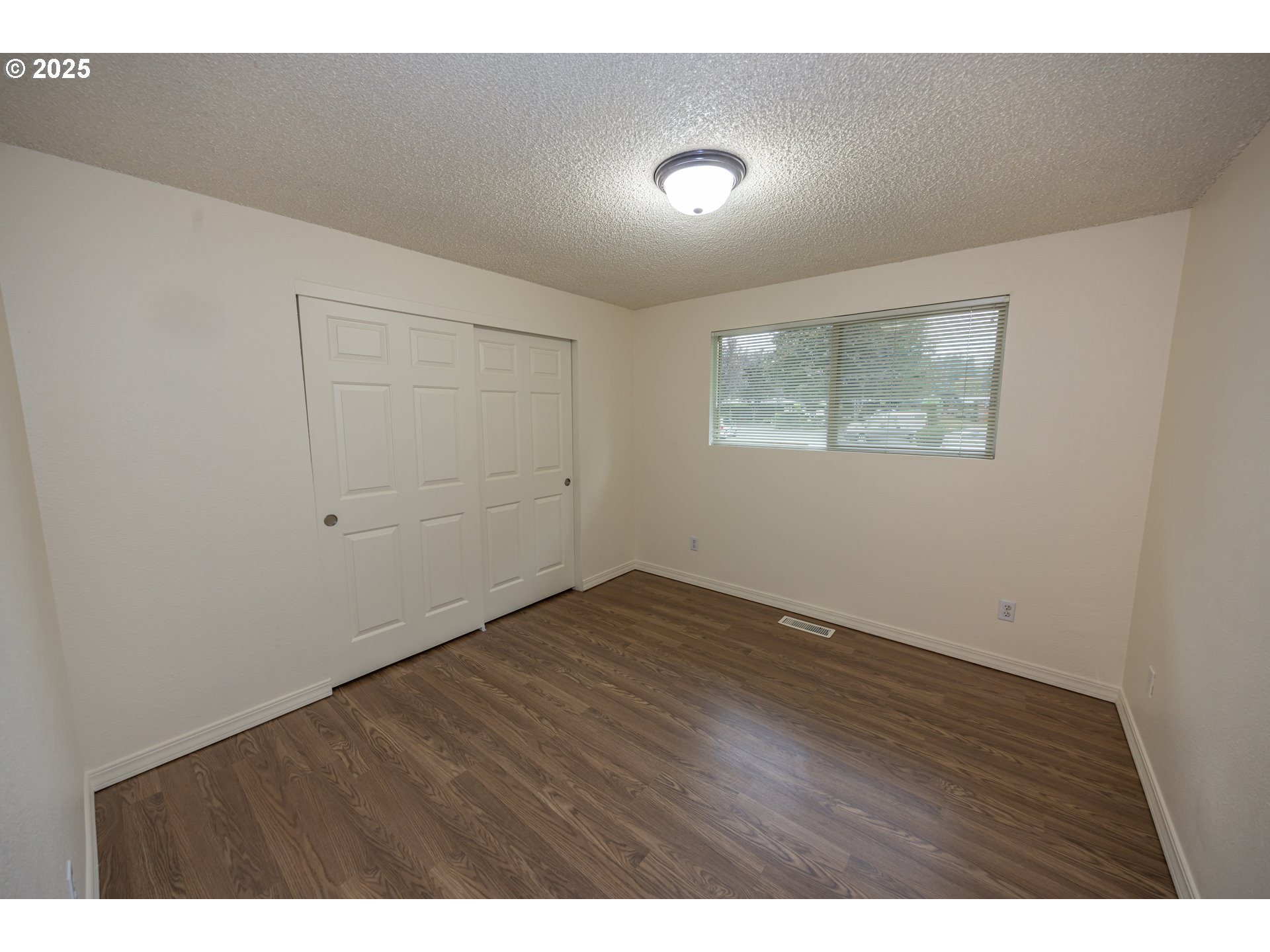 3600 A Street, Unit 6 Washougal, WA 98671 - Photo 11 of 15 a view of an empty room with wooden floor and a window