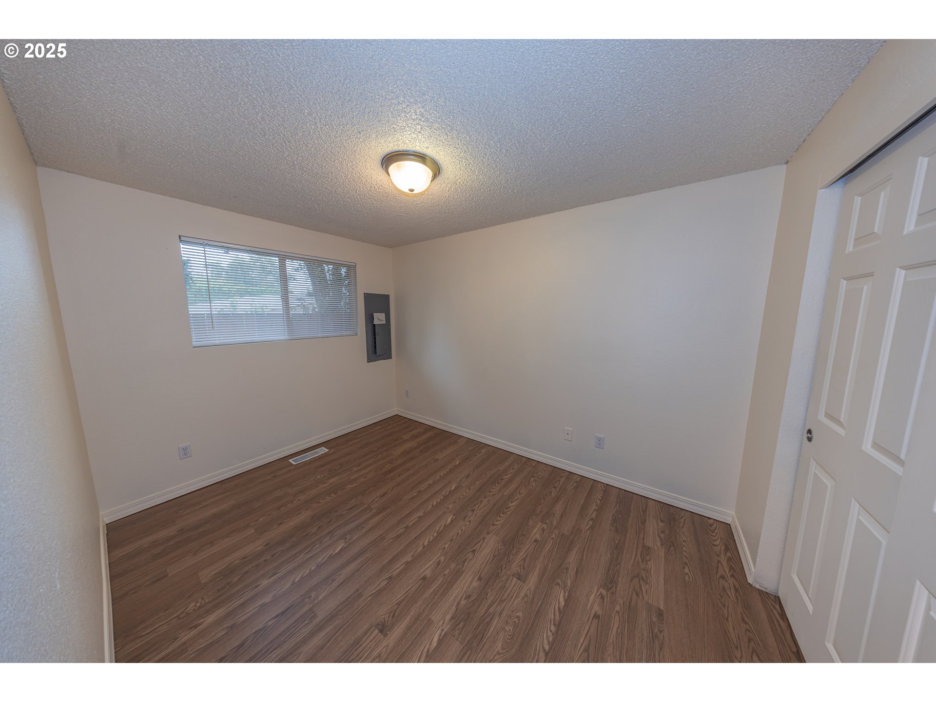 3600 A Street, Unit 6 Washougal, WA 98671 - Photo 12 of 15 a view of an empty room with wooden floor and a window
