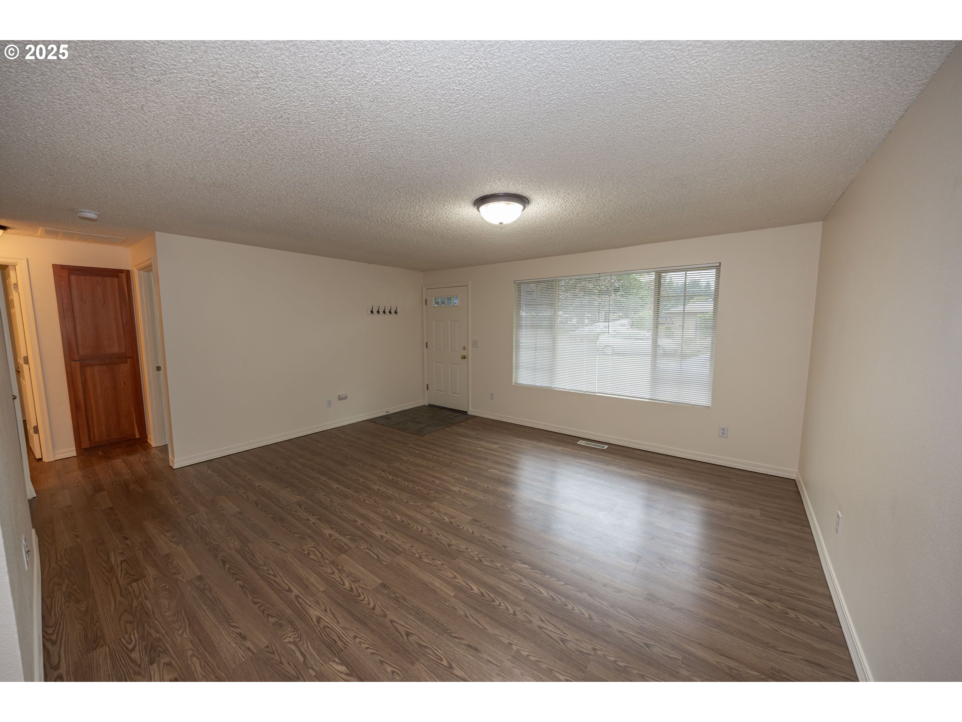 3600 A Street, Unit 6 Washougal, WA 98671 - Photo 5 of 15 a view of an empty room with wooden floor and a window