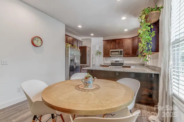 a kitchen with kitchen island a appliances a sink and a dining table view