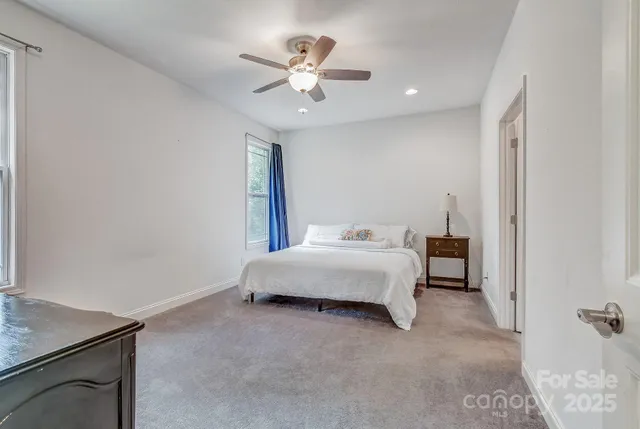 a bedroom with a bed and a ceiling fan