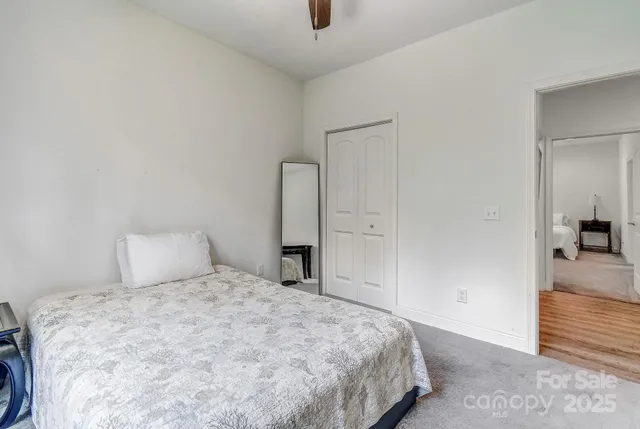 a bedroom with a bed and a view of bathroom