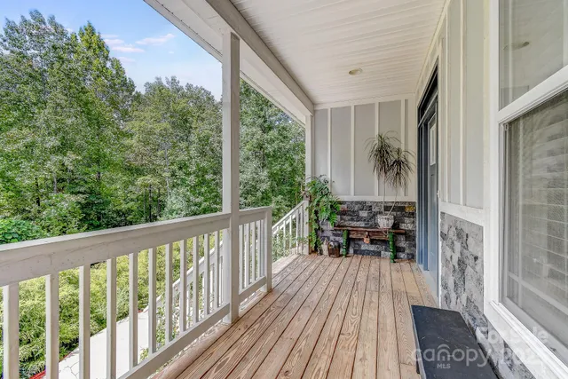 a view of balcony with chairs and wooden floor