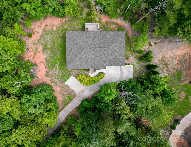 an aerial view of a house with a yard and lake view