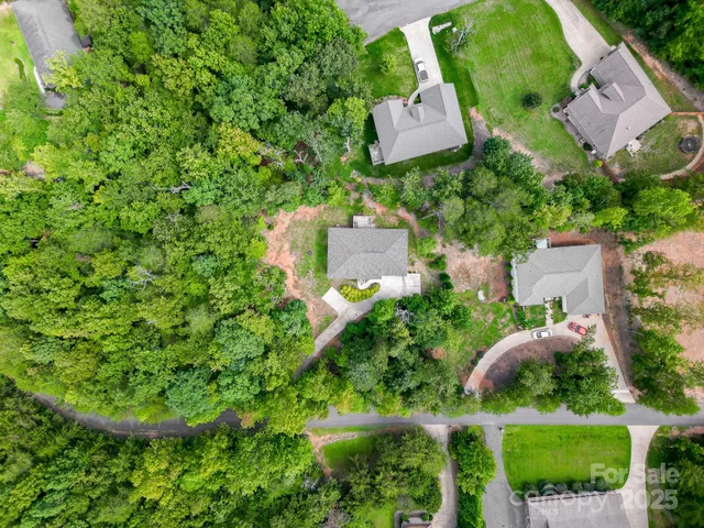 an aerial view of a house with yard