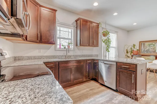 a kitchen with stainless steel appliances granite countertop sink stove and granite counter top