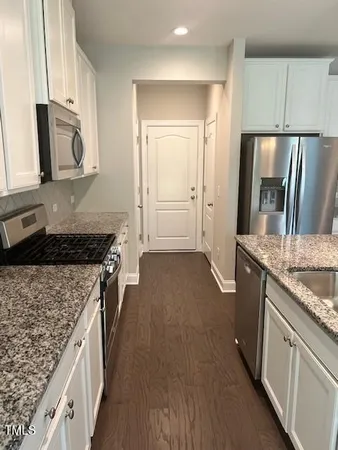 a view of a room with wooden floor and cabinet