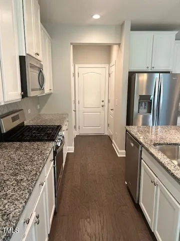 a view of a room with wooden floor and cabinet