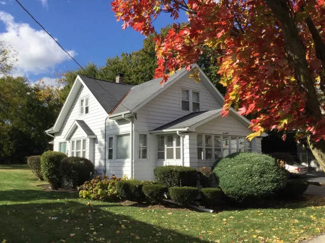 a front view of a house with a garden and plants