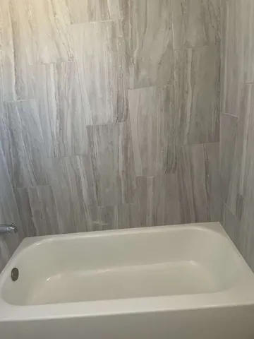 an empty room with wooden floor and door