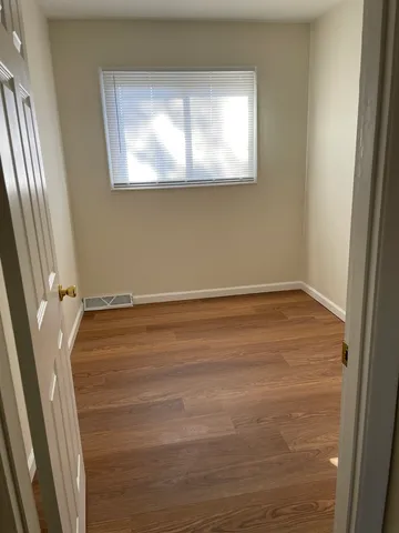 a view of an empty room and wooden floor