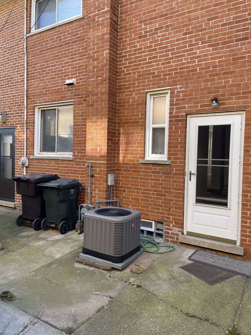10059 Frontage Road, Unit F Skokie, IL 60077 - Photo 23 of 34 a brick house with four windows