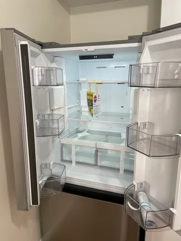 a kitchen with cabinets and wooden floor