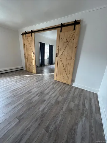 a view of an entryway with wooden floor