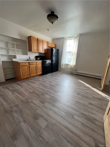 a view of kitchen with sink microwave and cabinets