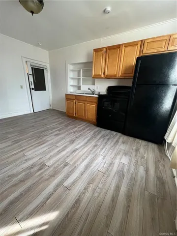 a kitchen with stainless steel appliances wooden cabinets a refrigerator and a stove