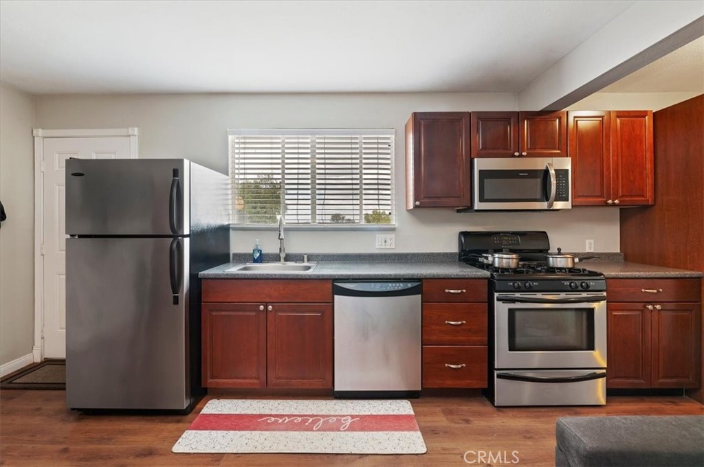 16420 Rocky Glen Road Perris, CA 92570 - Photo 62 of 74 a kitchen with stainless steel appliances granite countertop a stove a refrigerator and a microwave