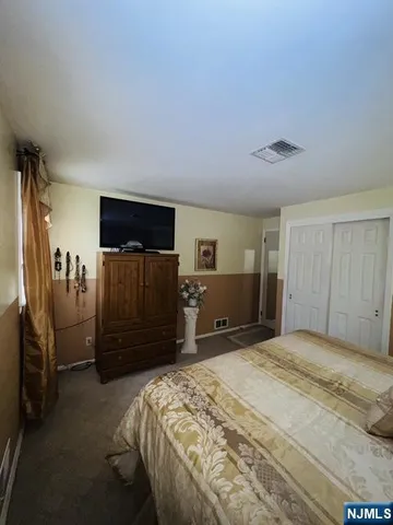 a bedroom with a bed and a closet