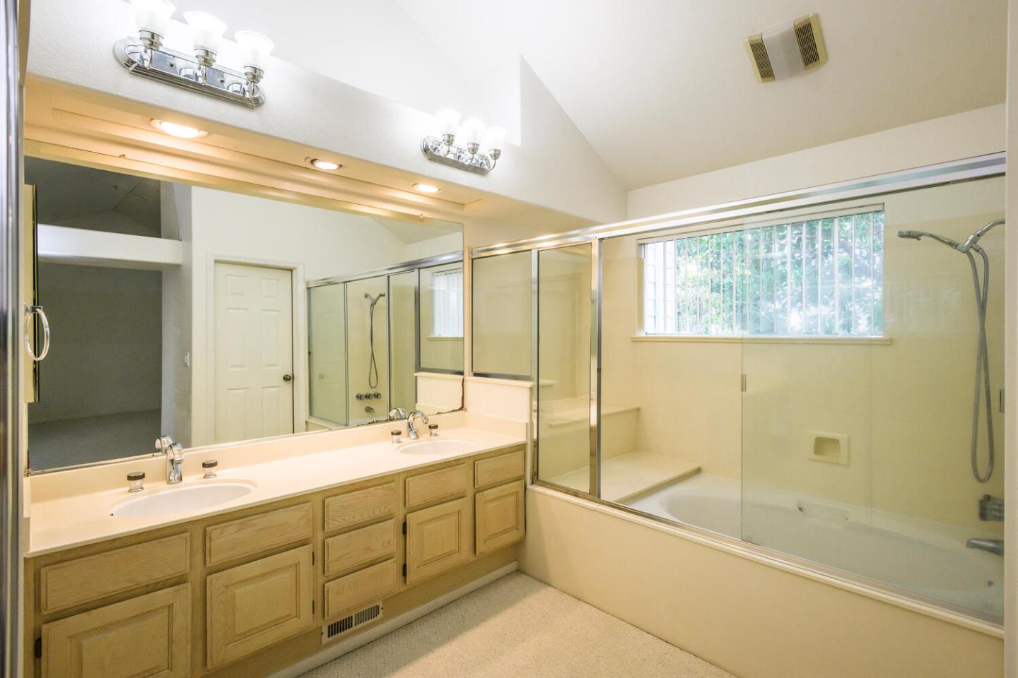 848 Columbia Circle Redwood City, CA 94065 - Photo 13 of 19 a bathroom with a double vanity sink mirror and a bathtub