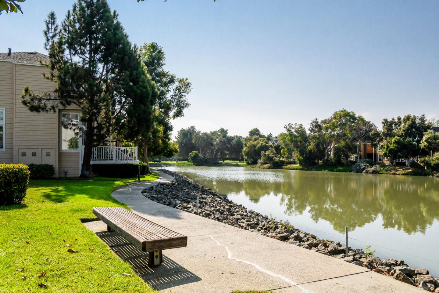 848 Columbia Circle Redwood City, CA 94065 - Photo 19 of 19 a wooden bench sitting next to a lake