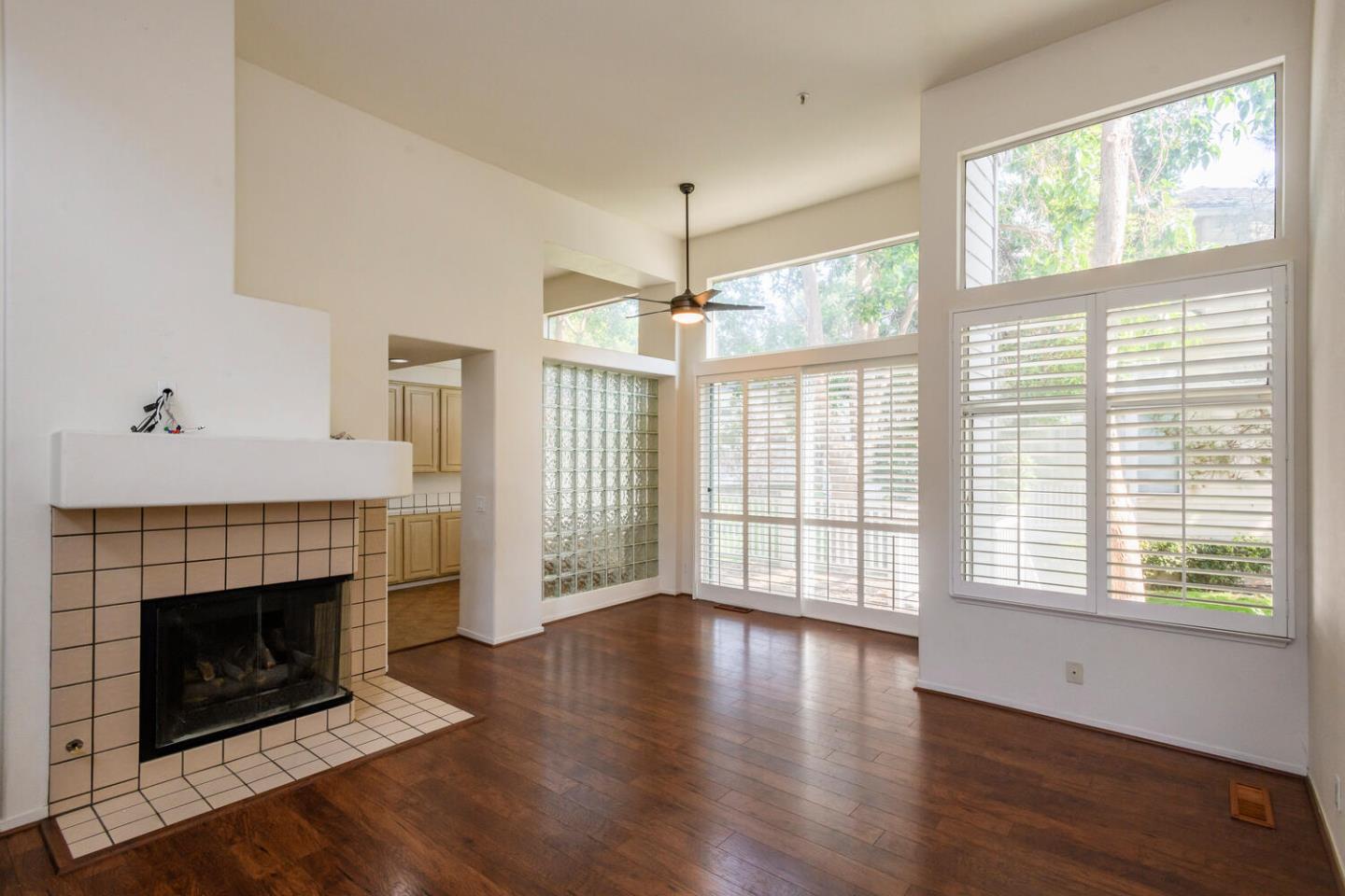848 Columbia Circle Redwood City, CA 94065 - Photo 3 of 19 a view of an empty room with wooden floor fireplace and a window