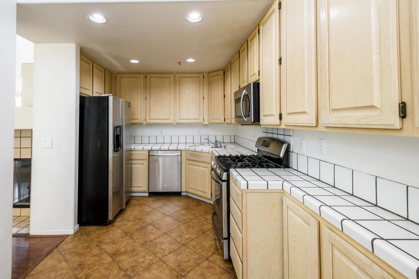 848 Columbia Circle Redwood City, CA 94065 - Photo 4 of 19 a kitchen with a stove a refrigerator and a sink