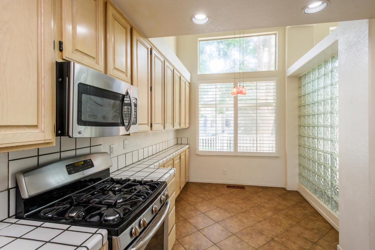 848 Columbia Circle Redwood City, CA 94065 - Photo 5 of 19 a kitchen with stainless steel appliances a stove and a microwave