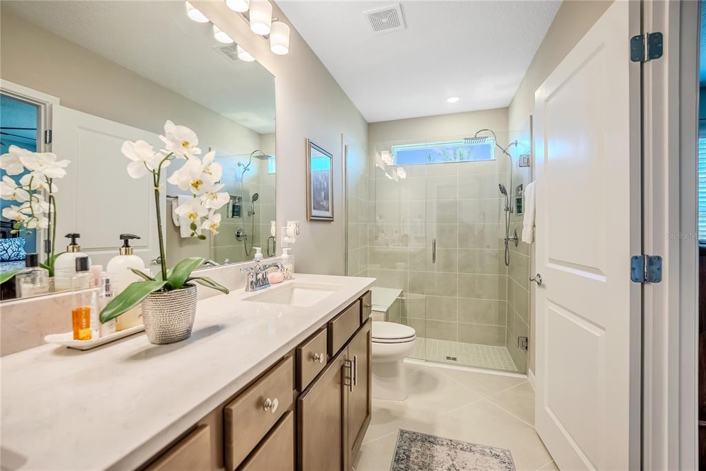 8344 Southwest 54th Loop Ocala, FL 34481 - Photo 14 of 36 a bathroom with a sink a toilet and shower