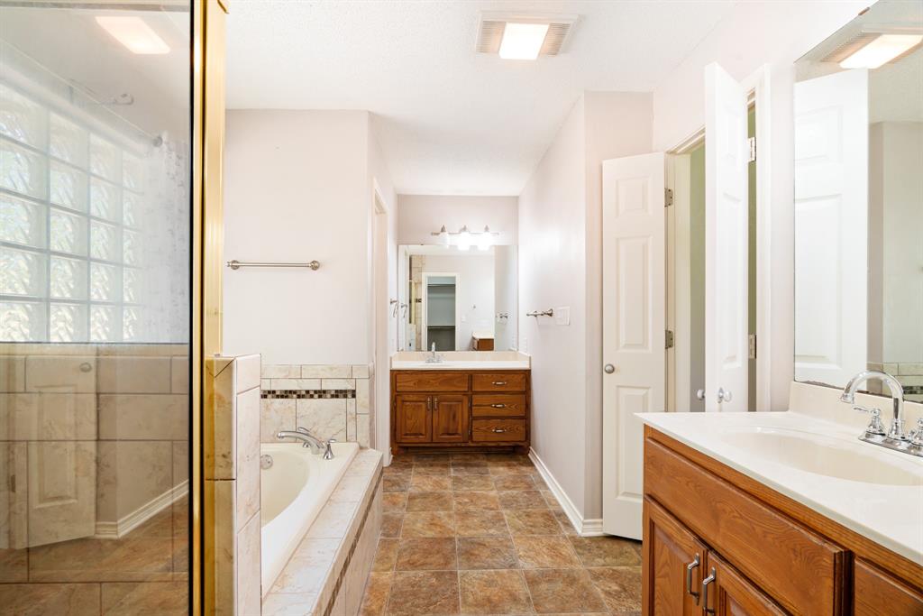 239 Deer Valley Drive Powderly, TX 75473 - Photo 11 of 18 a bathroom with a tub sink and mirror