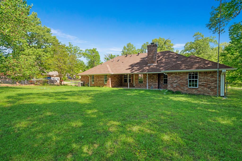 239 Deer Valley Drive Powderly, TX 75473 - Photo 18 of 18 a front view of house with yard and green space
