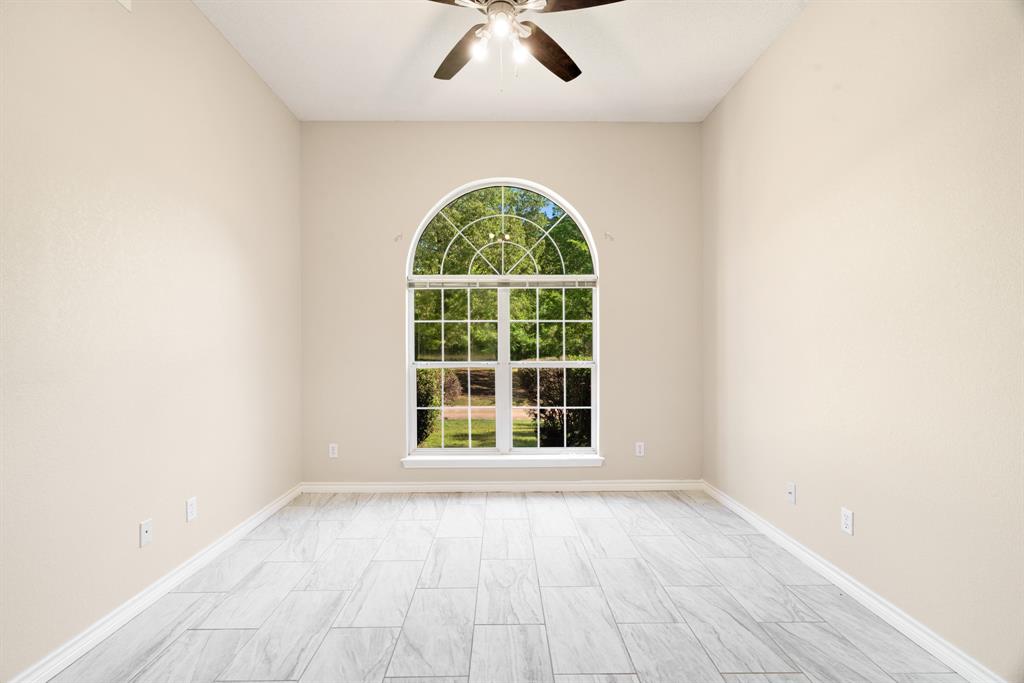 239 Deer Valley Drive Powderly, TX 75473 - Photo 5 of 18 an empty room with a window and a space