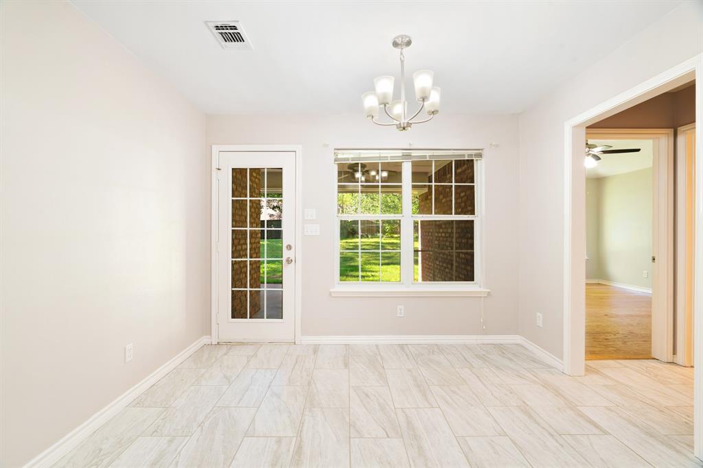 239 Deer Valley Drive Powderly, TX 75473 - Photo 8 of 18 an empty room with wooden floor and windows