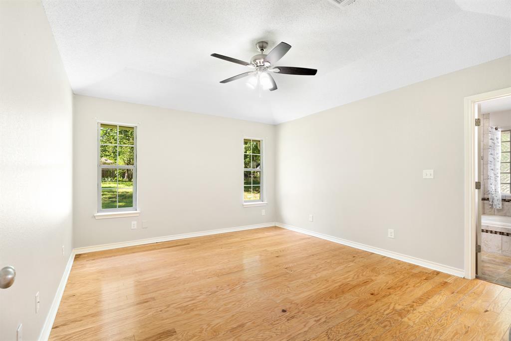 239 Deer Valley Drive Powderly, TX 75473 - Photo 9 of 18 a view of empty room with window and ceiling fan
