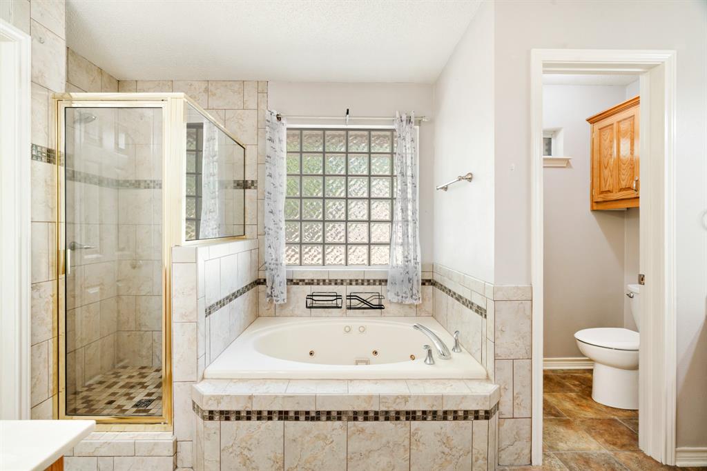 239 Deer Valley Drive Powderly, TX 75473 - Photo 10 of 18 a bathroom with a tub and shower