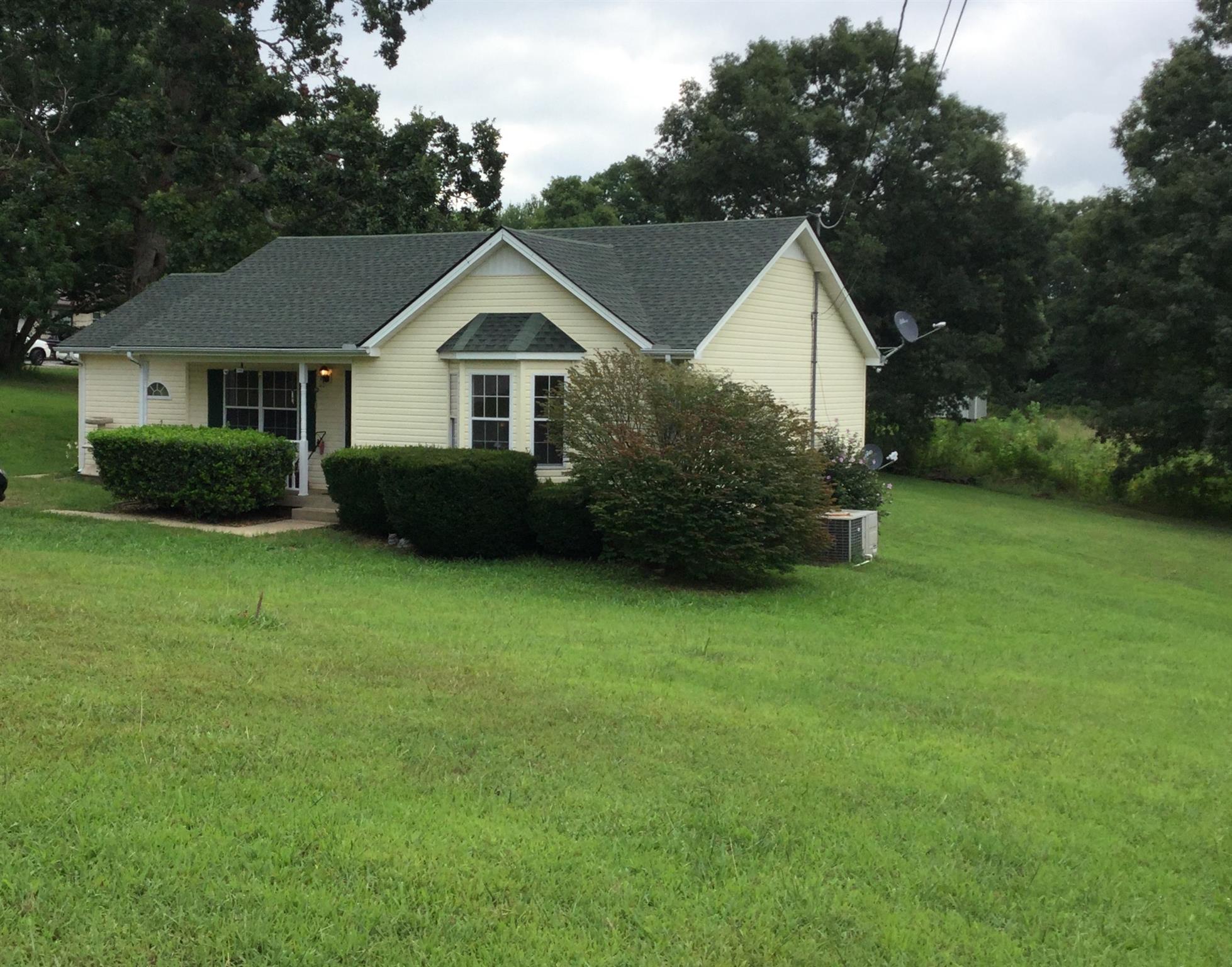 921 Hargrove Road West Dickson, TN 37055 - Photo 1 of 10 a front view of a house with a yard and trees