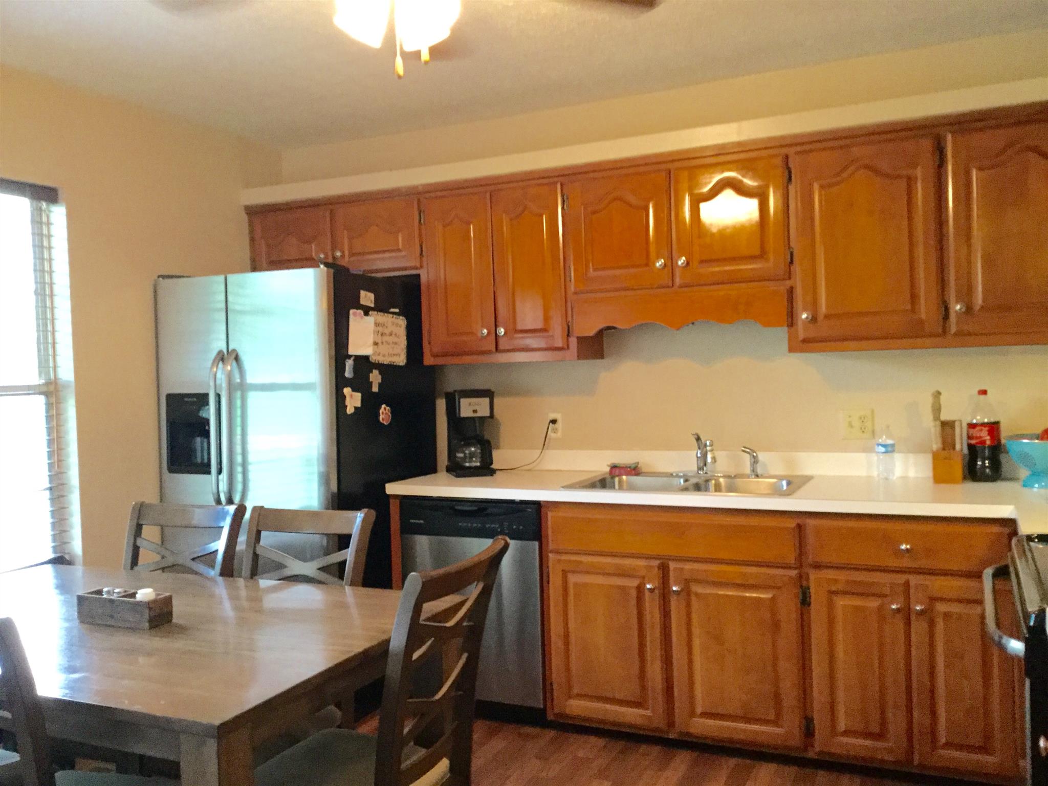 921 Hargrove Road West Dickson, TN 37055 - Photo 2 of 10 a kitchen with a sink cabinets and wooden floor