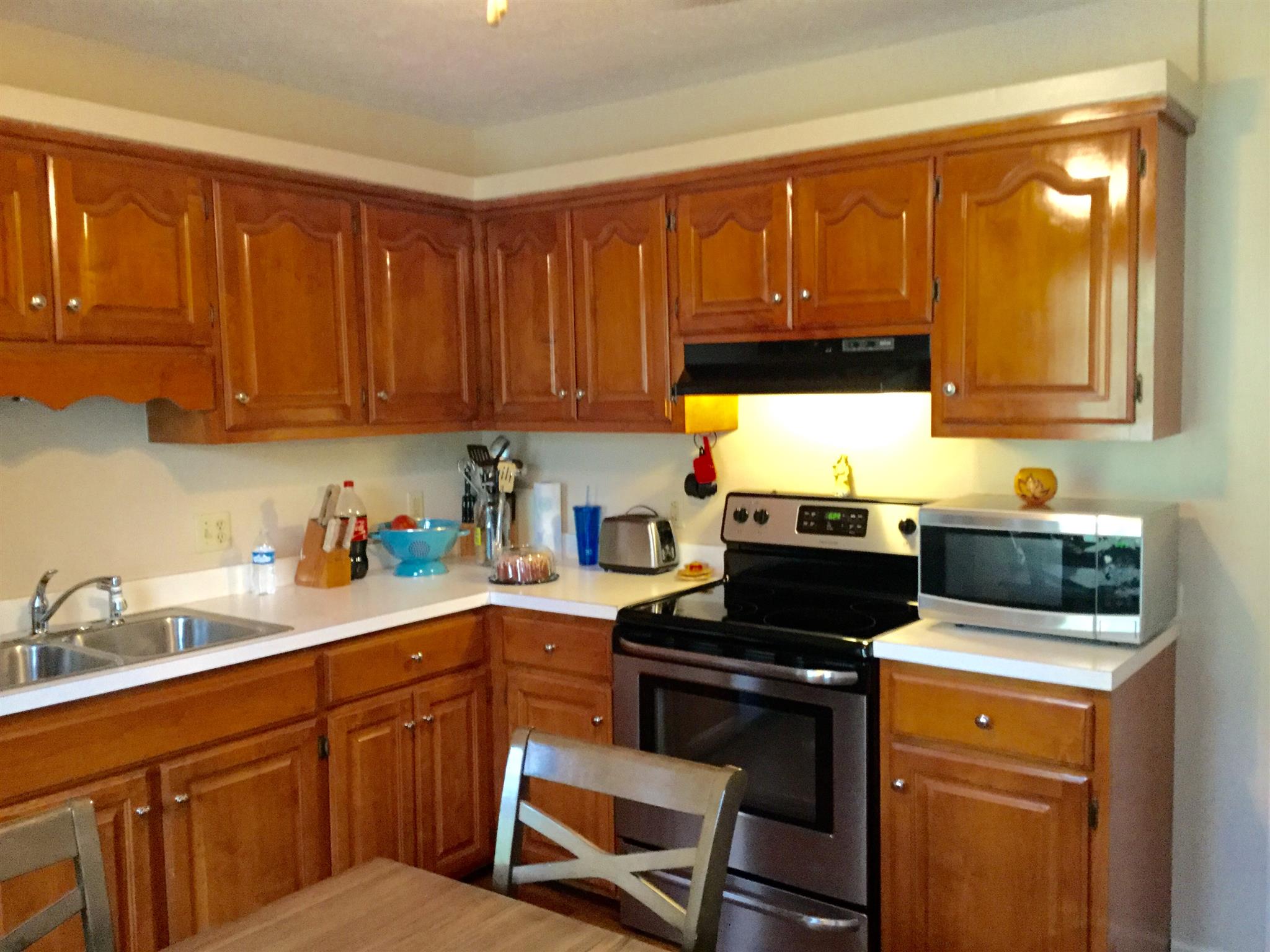 921 Hargrove Road West Dickson, TN 37055 - Photo 3 of 10 a kitchen with a sink and wooden cabinets