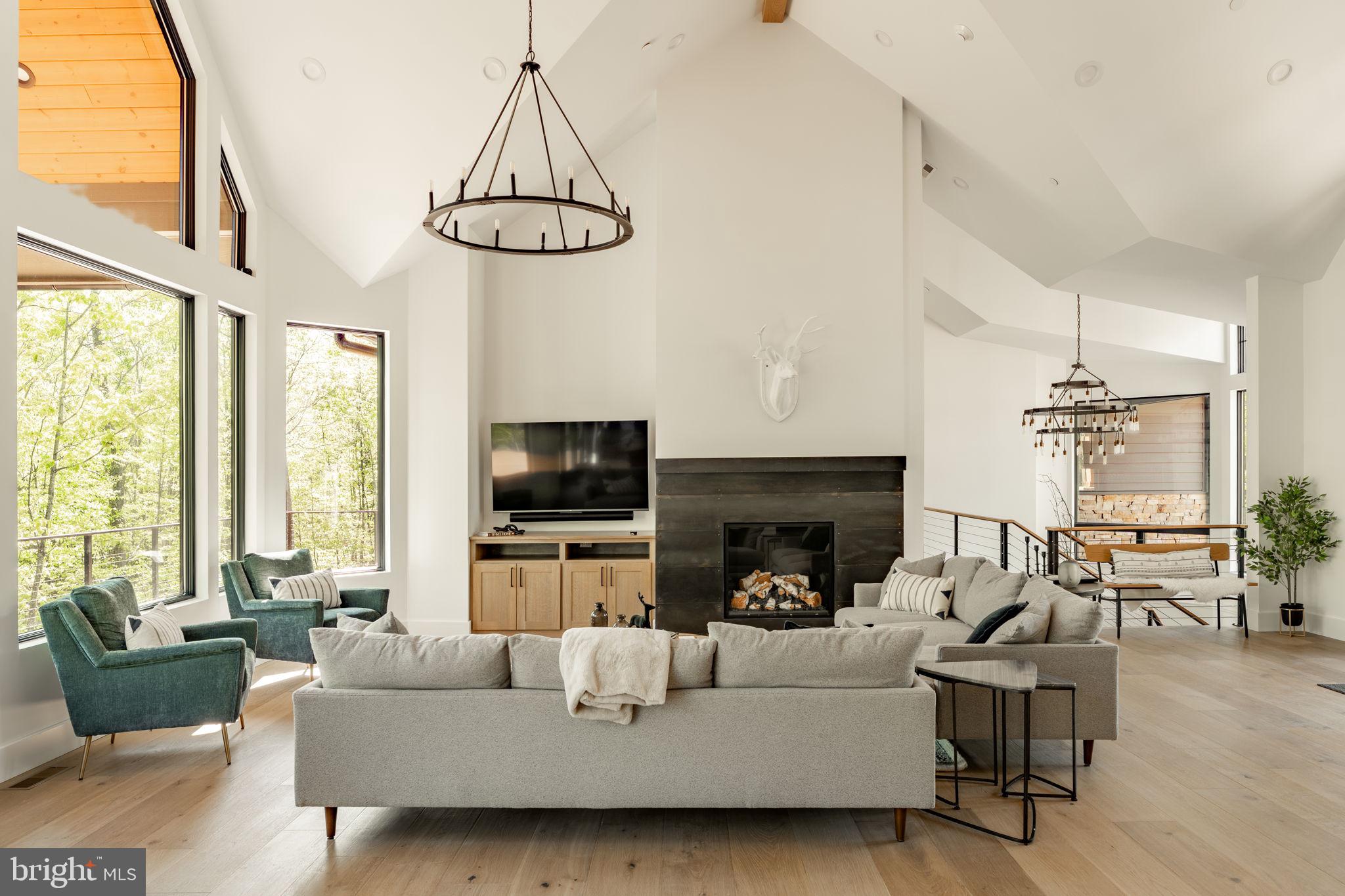 422 Mountaintop Road McHenry, MD 21541 - Photo 9 of 107 a living room with furniture a flat screen tv and a large window
