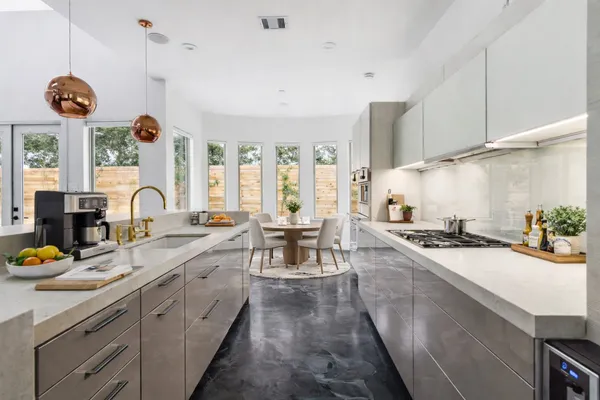 a kitchen with sink stove and cabinets