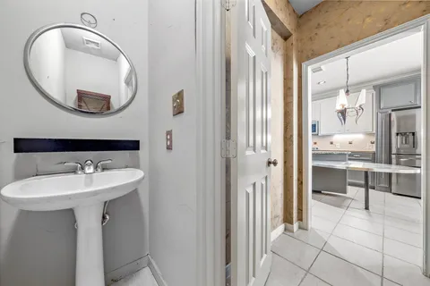 a bathroom with a sink a mirror a vanity and a shower