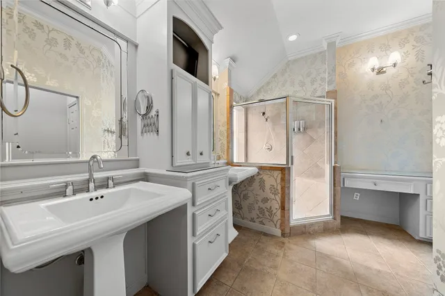 a spacious bathroom with a double vanity sink mirror and shower