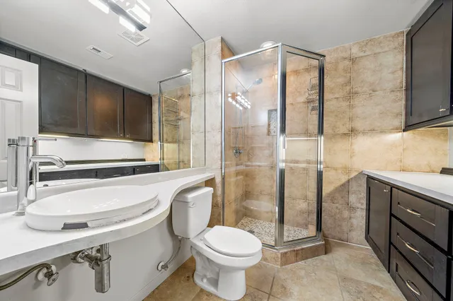 a bathroom with a sink toilet and shower